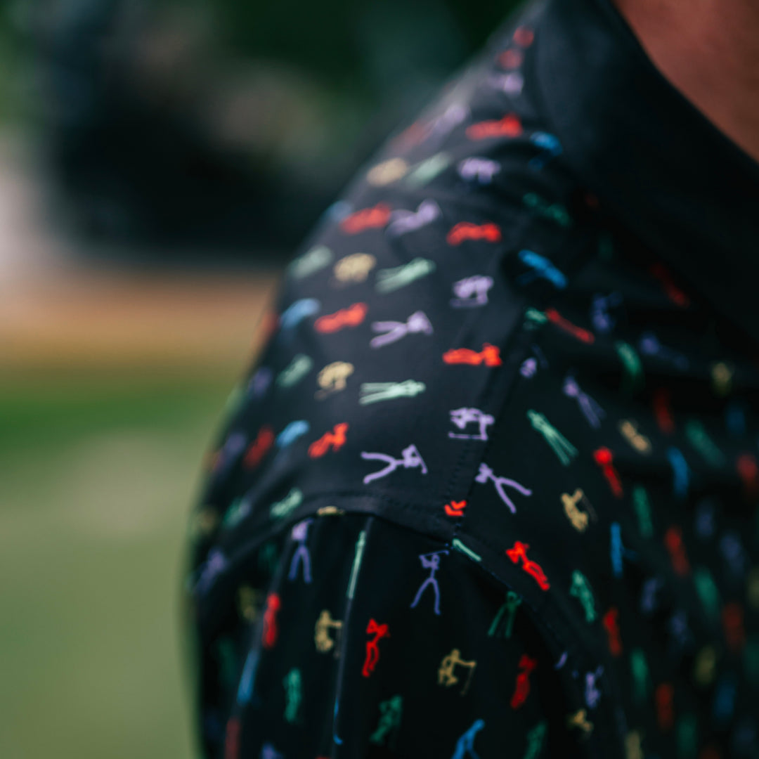 Stick figure golfer pattern close up on a black RealGolfers Polo.