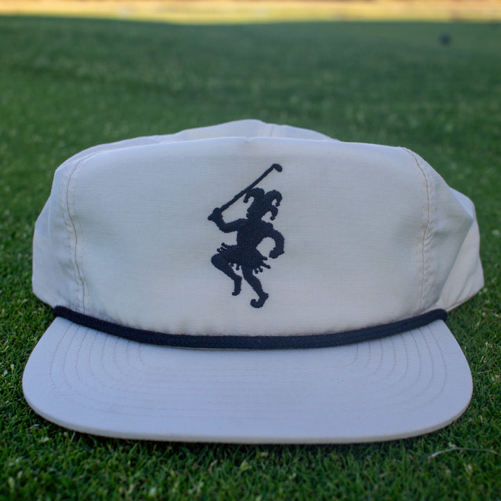 White rope hat with a black rope, and a golfing jester logo embroidered on the front.