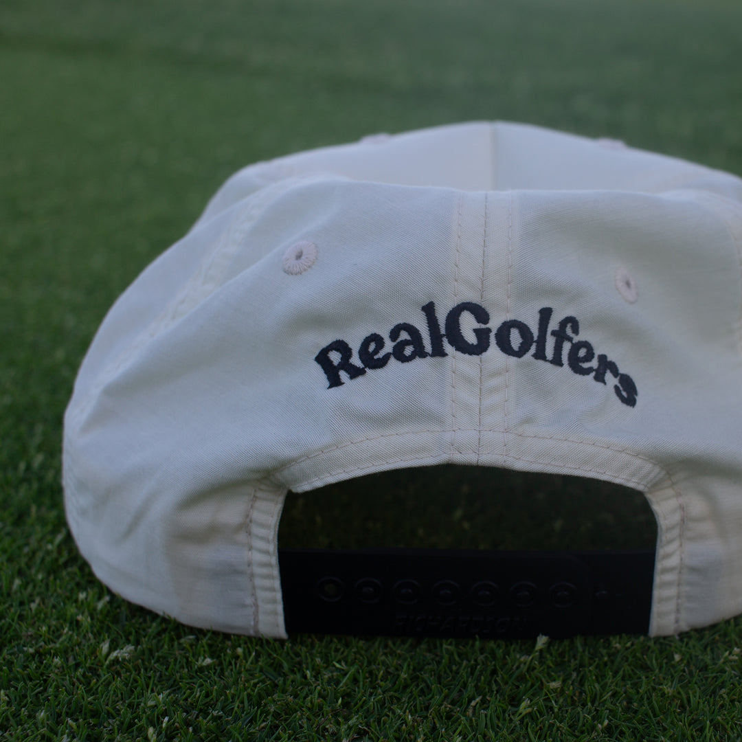 Back side of the white golf hat. Embroidered "RealGolfers" logo, black snapback.