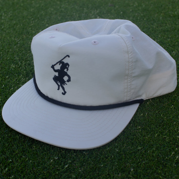 White golf hat with a black rope and dancing Jester Logo embroidered on the front.